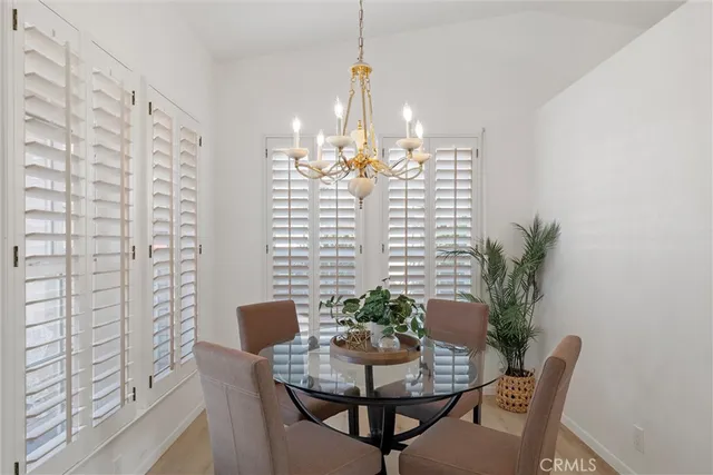 a view of a dining room with furniture and a chandelier