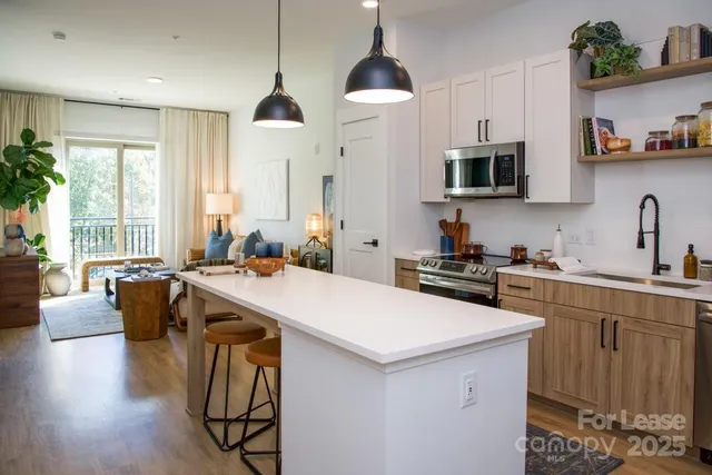 a bedroom with 2 bed and a painting on the wall