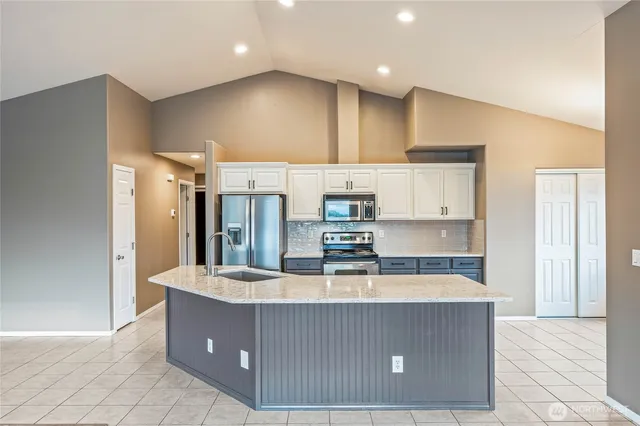 a kitchen with kitchen island cabinets and refrigerator