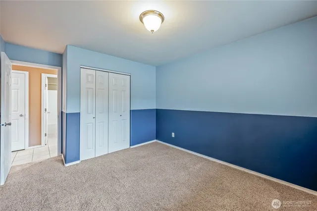 an empty room with closet area