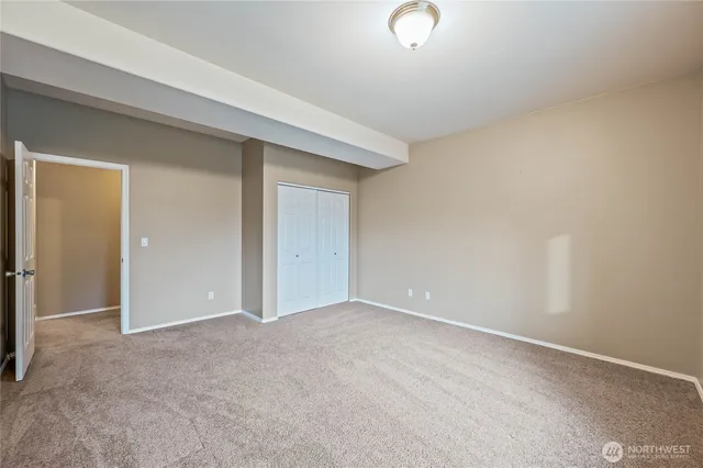 an empty room with closet area