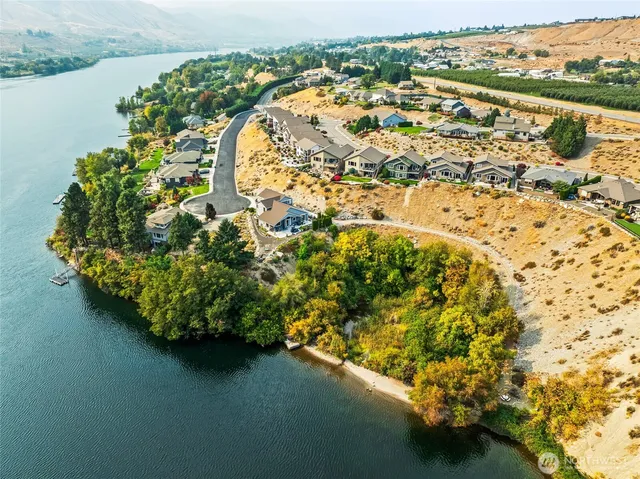 an aerial view of a house with a lake view