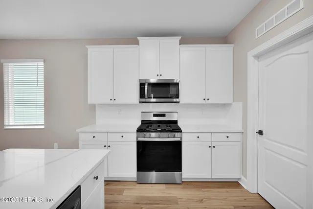 a kitchen with a stove and a sink