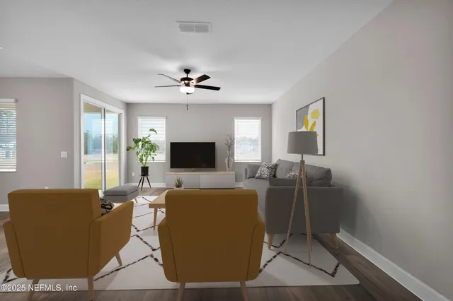 a living room with furniture a flat screen tv and a fireplace