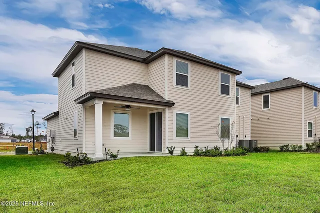 a front view of house with yard and green space