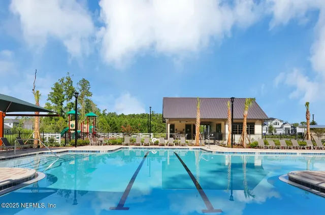 a swimming pool view with a outdoor seating