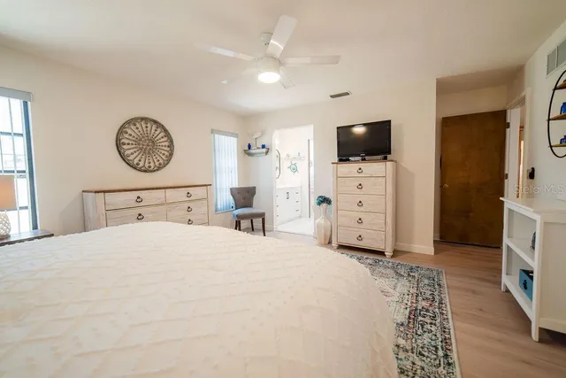 a bedroom with a bed and a television in it