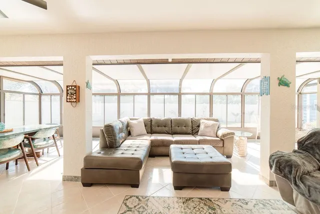 a living room with furniture and large windows