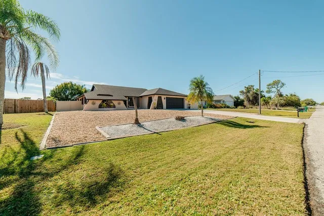a swimming pool with some plants and large trees
