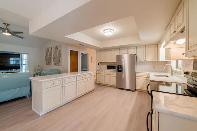 a kitchen with white cabinets and white appliances