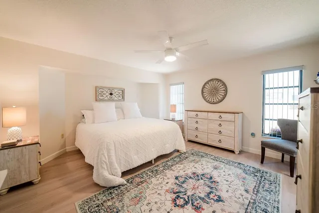 a bedroom with a bed a mirror and dresser