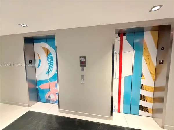 a view of living room filled with furniture and white walls