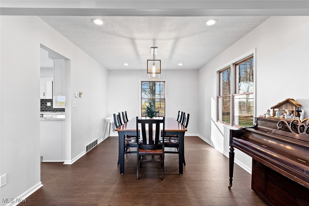 9757 Easton Road Rittman, OH 44270 - Photo 10 of 33 Dining room featuring dark wood-type flooring and a textured ceiling