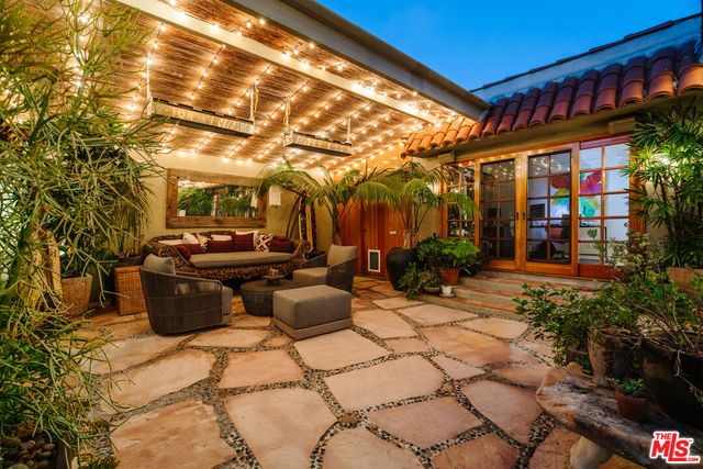 a view of a patio with table and chairs and potted plants