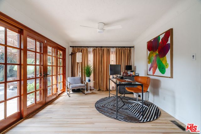 a reading room with furniture wooden floor and a window