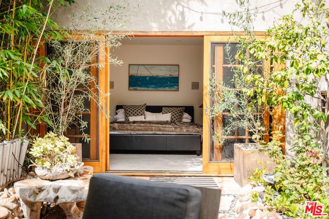a living room with a couch and a potted plant