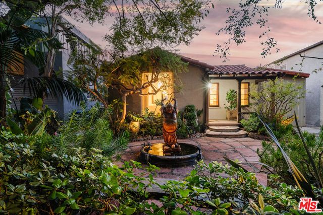a view of a house with swimming pool and sitting area