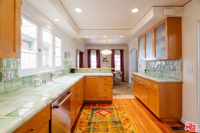 a large kitchen with kitchen island granite countertop a large window