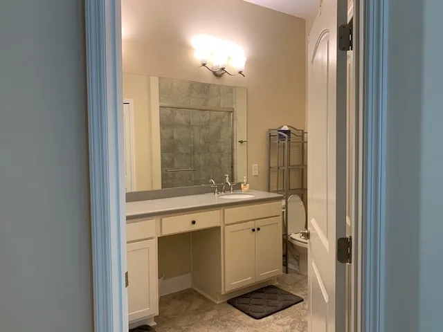 a bathroom with a double vanity sink a mirror and a shower