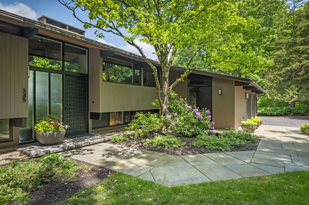 345 Cartwright Road Needham, MA 02492 - Photo 1 of 42 a house view with a garden space