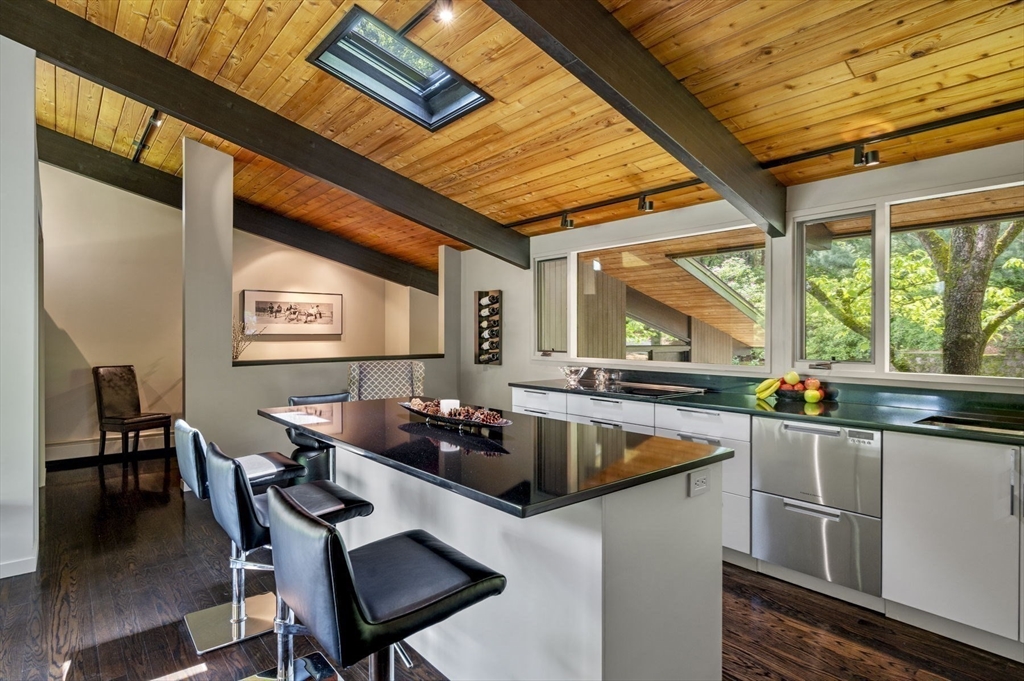345 Cartwright Road Needham, MA 02492 - Photo 13 of 42 a kitchen with a table chairs and a dining table