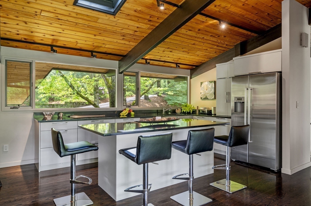 345 Cartwright Road Needham, MA 02492 - Photo 14 of 42 a kitchen with stainless steel appliances granite countertop table chairs and a large window