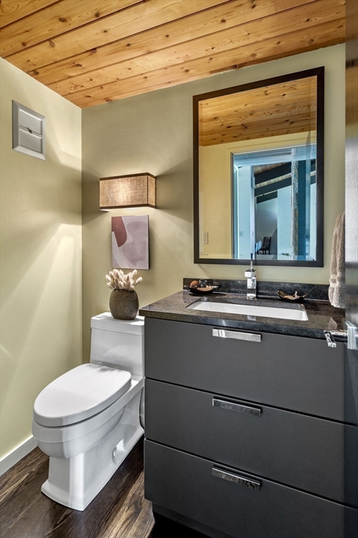 345 Cartwright Road Needham, MA 02492 - Photo 18 of 42 a bathroom with a toilet a sink and mirror