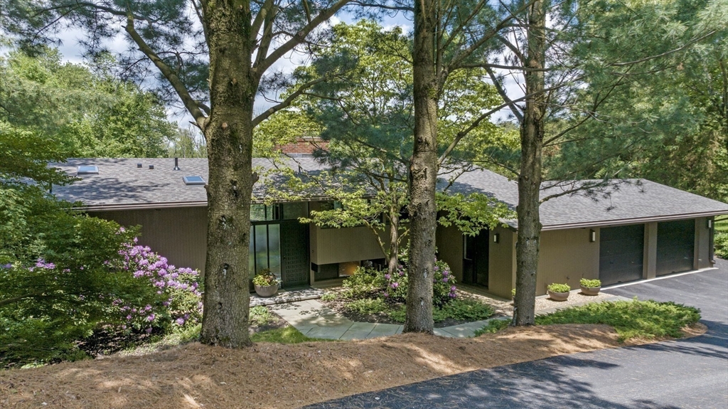 345 Cartwright Road Needham, MA 02492 - Photo 2 of 42 a front view of a house with garden