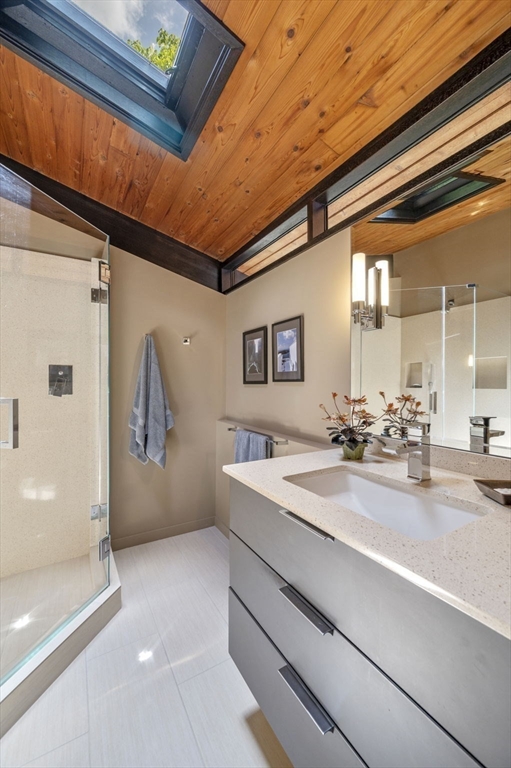345 Cartwright Road Needham, MA 02492 - Photo 23 of 42 a bathroom with a sink a mirror and a shower