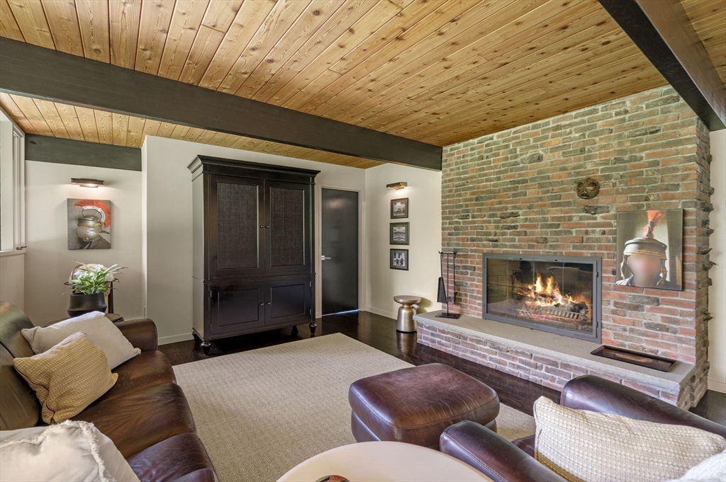 345 Cartwright Road Needham, MA 02492 - Photo 26 of 42 a living room with furniture and a fireplace