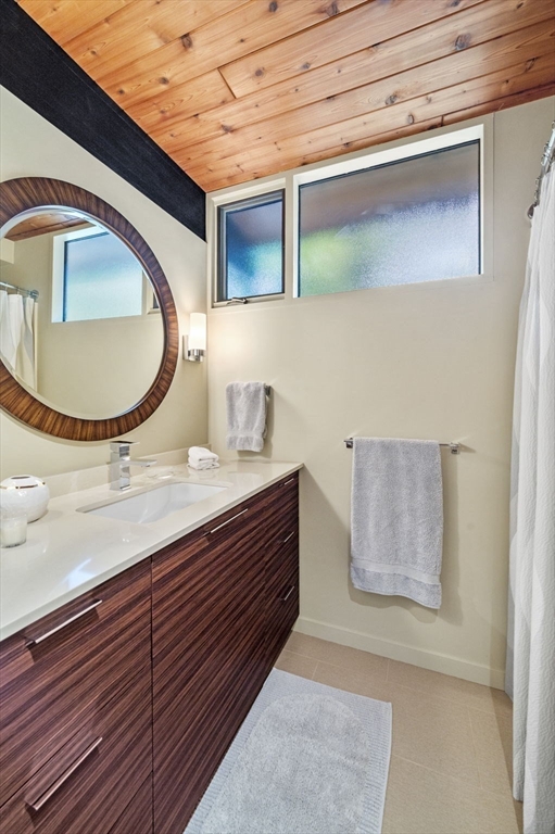 345 Cartwright Road Needham, MA 02492 - Photo 27 of 42 a bathroom with a sink and a mirror