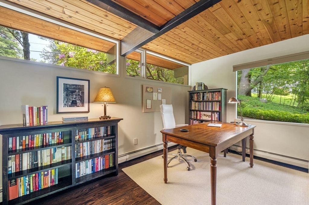 345 Cartwright Road Needham, MA 02492 - Photo 30 of 42 a view of a workspace with furniture and a book shelf