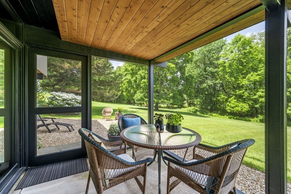345 Cartwright Road Needham, MA 02492 - Photo 33 of 42 a view of a porch with furniture and a yard