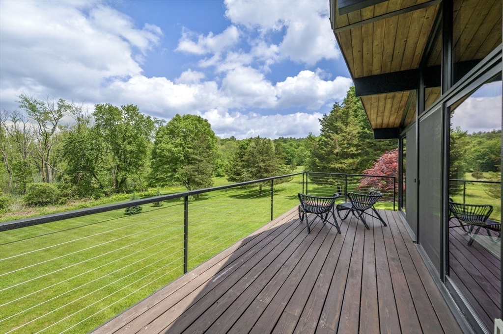 345 Cartwright Road Needham, MA 02492 - Photo 6 of 42 a view of a chairs and table on the wooden floor