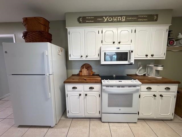 11075 Highway 57 Moscow, TN 38057 - Photo 11 of 39 a kitchen with white cabinets and white appliances