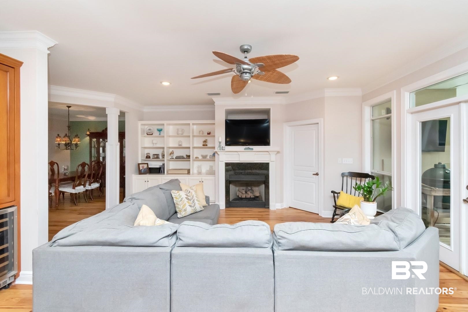 3500 North Riviere Du Chien Loop Mobile, AL 36693 - Photo 5 of 74 Living room featuring ceiling fan with notable chandelier, light wood-type flooring, and crown molding