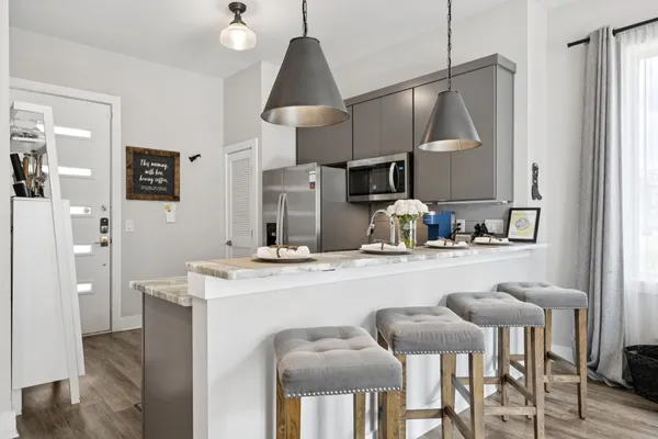 a kitchen with stainless steel appliances granite countertop a sink a stove and a refrigerator