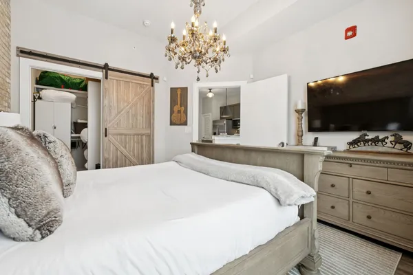 a bedroom with a bed and a flat screen tv