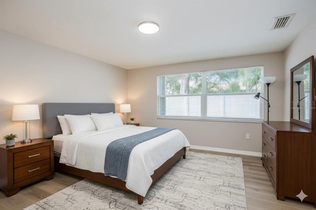 3538 Bluebell Lane Holiday, FL 34691 - Photo 11 of 25 a bedroom with a bed and a tv on table