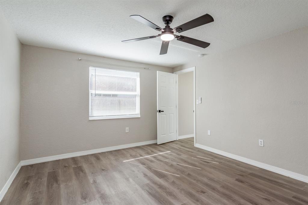 3538 Bluebell Lane Holiday, FL 34691 - Photo 13 of 25 wooden floor in an empty room with a window