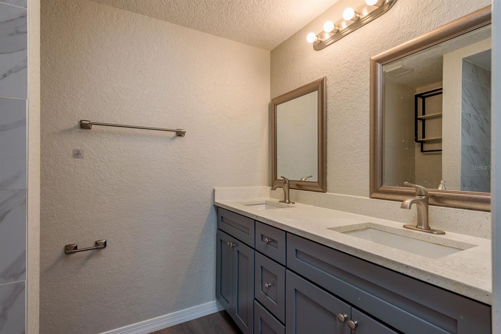 3538 Bluebell Lane Holiday, FL 34691 - Photo 14 of 25 a bathroom with a granite countertop sink and a mirror