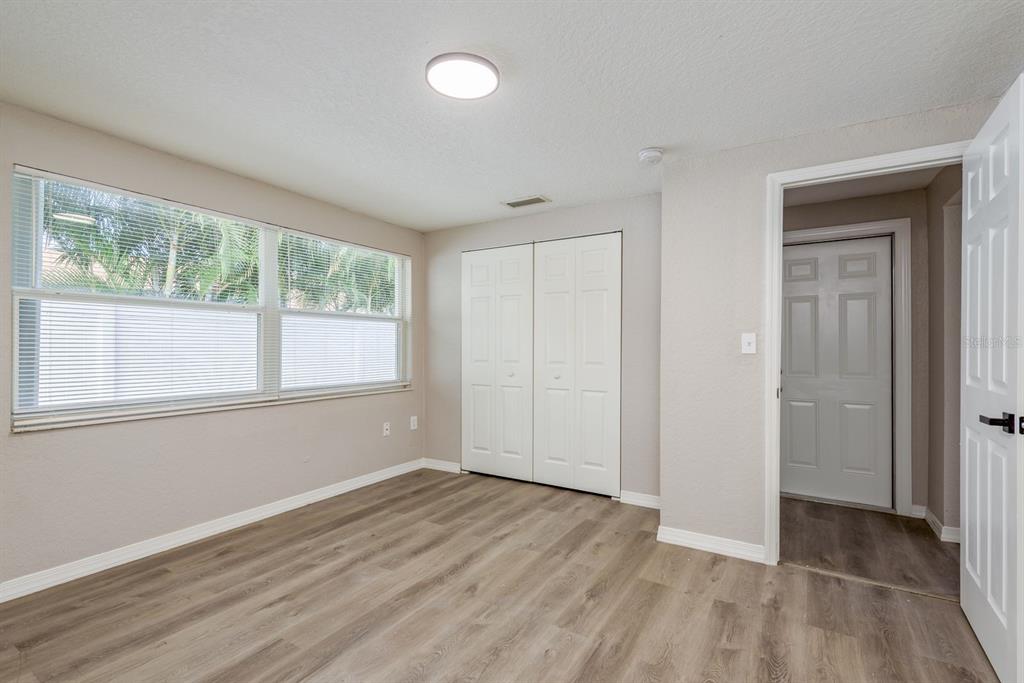 3538 Bluebell Lane Holiday, FL 34691 - Photo 16 of 25 an empty room with wooden floor and windows