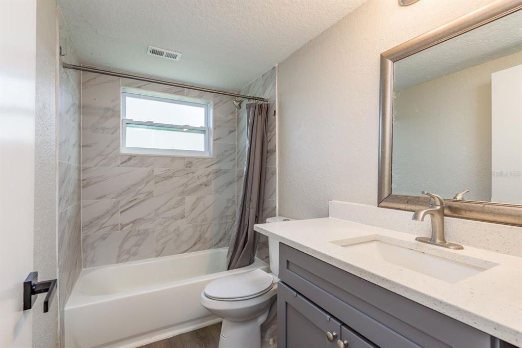 3538 Bluebell Lane Holiday, FL 34691 - Photo 18 of 25 a bathroom with a sink a toilet and a bathtub