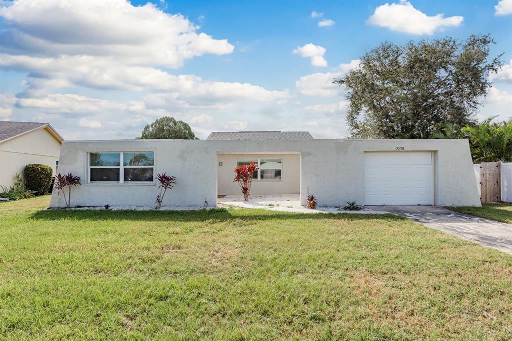 3538 Bluebell Lane Holiday, FL 34691 - Photo 20 of 25 a backyard of a house with table and chairs and wooden fence