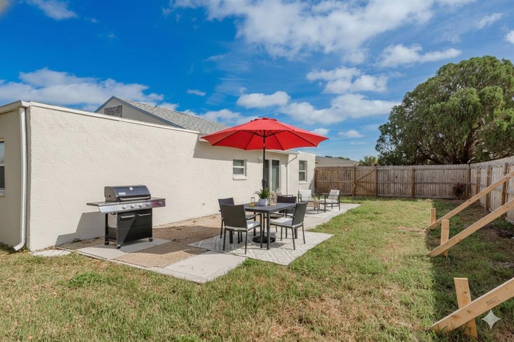 3538 Bluebell Lane Holiday, FL 34691 - Photo 21 of 25 a view of a backyard with furniture and a fire pit