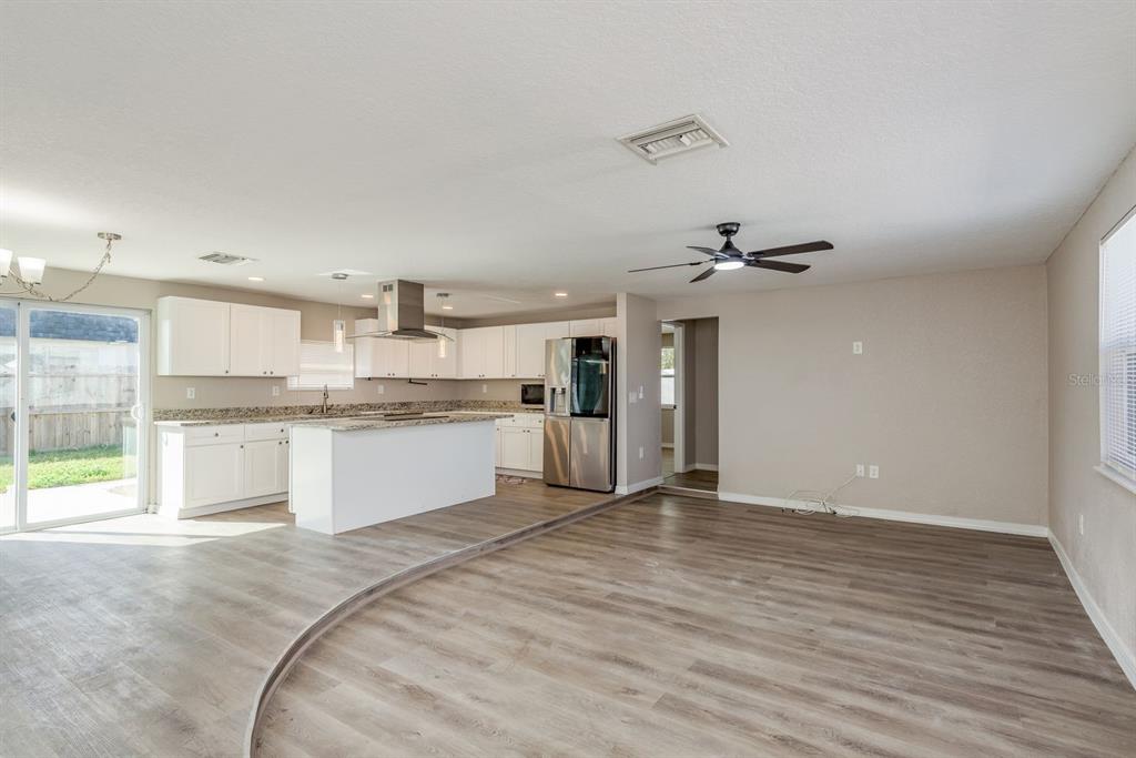 3538 Bluebell Lane Holiday, FL 34691 - Photo 5 of 25 a large kitchen with kitchen island a sink stainless steel appliances and cabinets