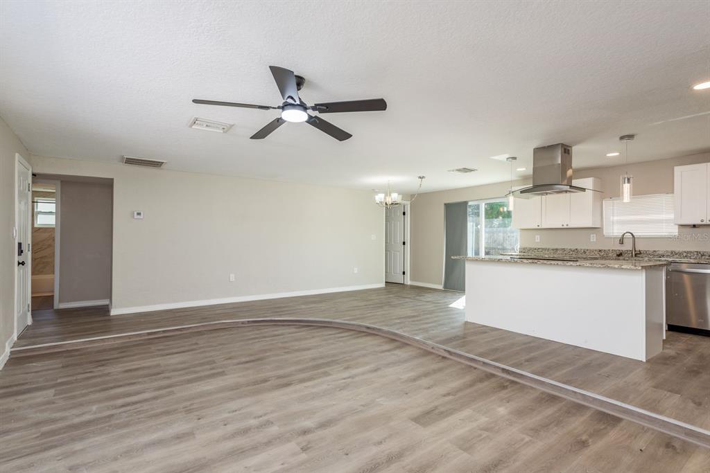 3538 Bluebell Lane Holiday, FL 34691 - Photo 6 of 25 a view of a kitchen with a sink and dishwasher a refrigerator with wooden floor