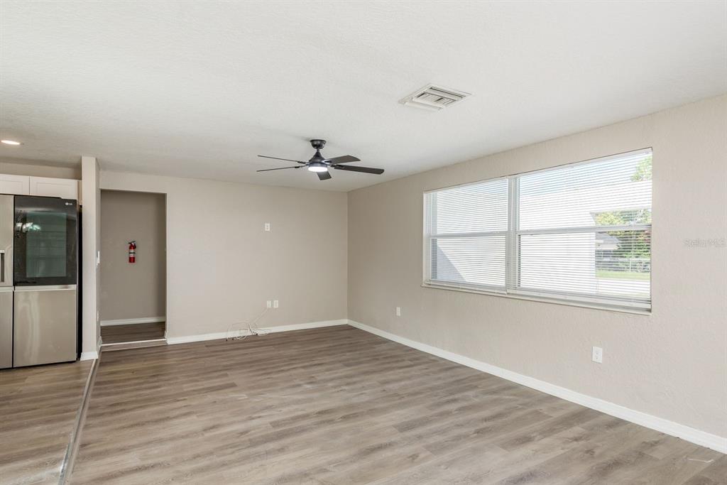 3538 Bluebell Lane Holiday, FL 34691 - Photo 7 of 25 wooden floor in an empty room with a window