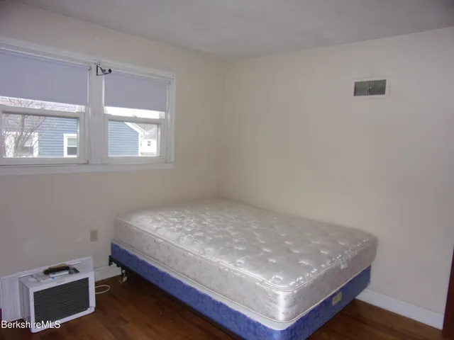 a room with a bed and a window