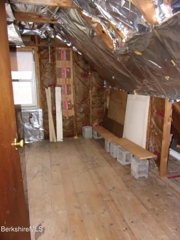 a view of an empty room with a fireplace